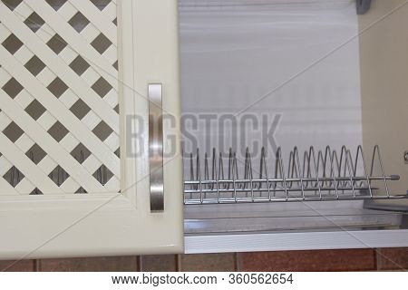 Empty Cupboard For Drying Dishes, Half Of The Open Drying Door In The Kitchen