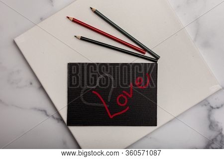 Love And Heart Painted On Black Canvas Art School Educational Supplies In The Background