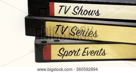 Vhs Tapes Stacked And With Labels Indicating The Various Genres Of Television Entertainment Recorded