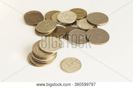 A Pile Of Golden Coins On A White Background