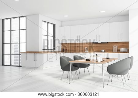 Corner Of Stylish Kitchen With White And Wooden Walls, Wooden Floor, White Countertops And Cupboards