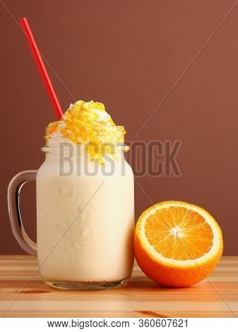 Milkshake Making On Wooden Table Closeup. Process Of Topping And Decorating Milkshake. Desset With C