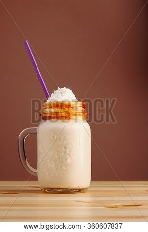 Caramel Frappucino Milkshake With Coffee On Wooden Table. Salted Caramel Ice Cream Sundae. Cold Coff