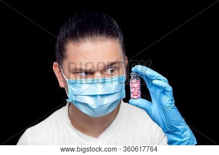 Doctor Virologist In Medical Mask And Sterile Gloves Raising An Eyebrow Contemptuously Looking At A 