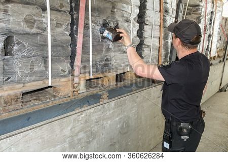 Krakovets, Ukraine - May, 2019: The Border Guard In Special Uniform Extracts Smuggling Cigarette Pac