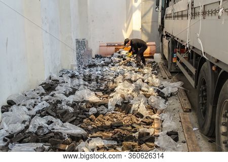 Krakovets, Ukraine - May, 2019: The Border Guard In Special Uniforms Throws Smuggled Cigarettes, Whi