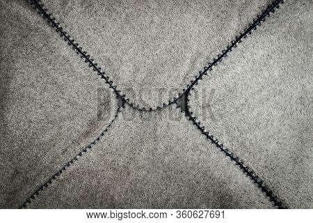Gray Spathe Folded In An Envelope With Blue Threading Edges With Black Vignette. Close-up Of Natural