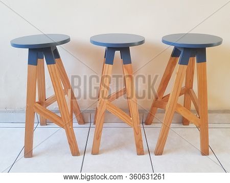 A Picture Of Three Wooden Bar Chair Lined Up Inside The House