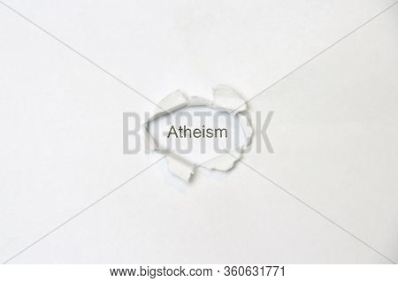 Word Atheism On White Isolated Background, The Inscription Through The Wound Hole In The Paper. Stoc