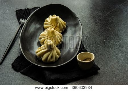 Traditional Georgian Khinkali Dish On Stone Background