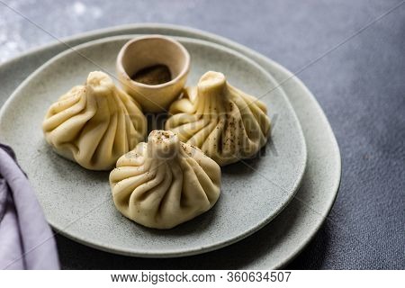 Traditional Georgian Khinkali Dish On Stone Background