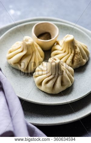 Traditional Georgian Khinkali Dish On Stone Background