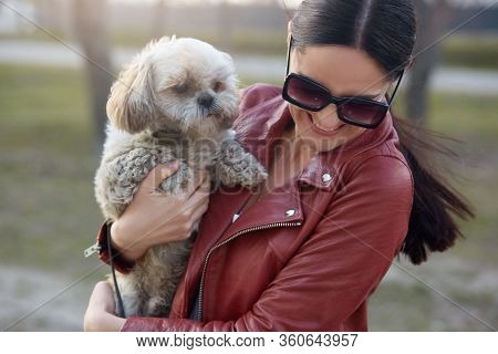 Outdoor Photo Of Positive Cheerful Young Lady In Sunglasses Smiling Sincerely, Being In Good Mood, H