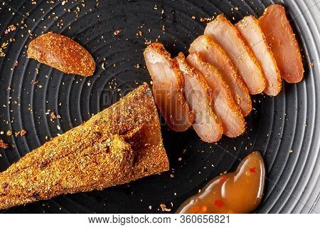 Seasoned Chicken With Hot Sauce And A Sprig Of Rosemary
