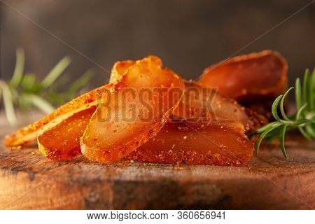 Seasoned Chicken With Hot Sauce And A Sprig Of Rosemary