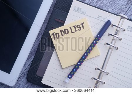 Top View Of To Do List On Notepad At Offie Table.