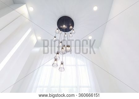 Looking Up On Suspended Ceiling With Halogen Spots Lamps And Drywall Construction In Empty Room In A