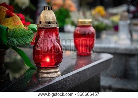 Red Candles On The Grave Devoted To All Souls Day
