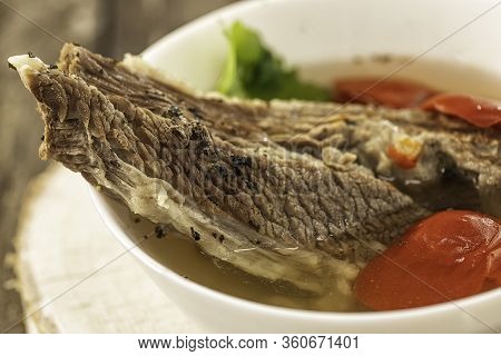 Shorpo In A White Plate With A Piece Of Beef Meat In A Broth With Vegetables Close Up