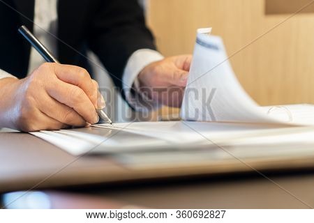 Businessman Signing Document Report File Binder In Business Concept: Manager Hands Holding Pen For R