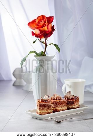 Layered Cakes With Rose On A White Marmorean Table.