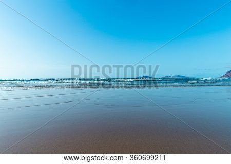 Panorama Of Beautiful Beach And Tropical Sea Of Lanzarote. Canaries. Coast Of Famara Beach, Lanzarot