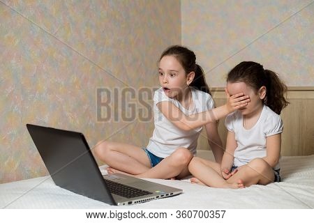 Little Girl Protects His Sister From Watching Inappropriate Content While Using A Computer. Internet