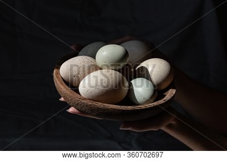 Araucana Eggs And Goose Eggs On A Wooden Plate