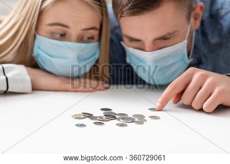 Family Bankruptcy. Upset Young Couple Counting Last Money Because Of Coronacrisis
