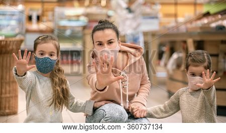 Mom And Kids Are Shopping At The Grocery Store.