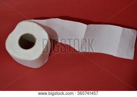 Roll Of Toilet Paper On Red Background