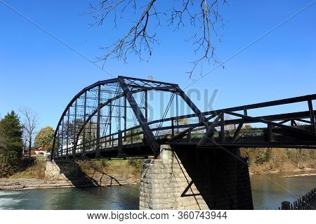 Black Steel Bridge Crosses The War Eagle River At War Eagle Mills In Northern Arkansas.  Historic Br