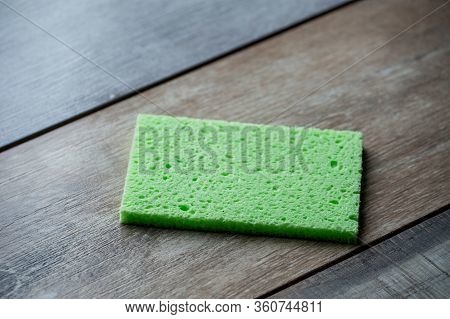 Cellulose Sponge Kitchen Objects On The Wood Texture Background. Cellulose Napkin On The Table