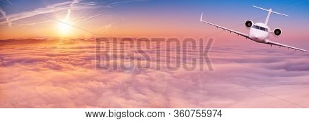 Small private jetplane flying above beautiful clouds. Travel and transportation concept.