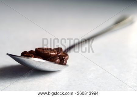 Coffee Beans And A White Cup On The Kitchen Table