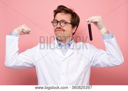 Scientist Hlding A Glass Tube With Blue Fluid Being Happy He Made A Great Discover.