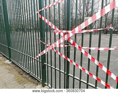 The Metal Door Closed With A Chain. The Door Is Tied With A Restraining Tape. Closed Areas During Qu