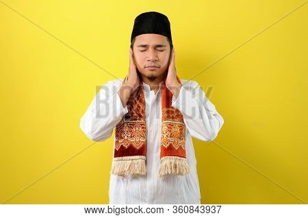 In Ramadan Kareem Young Asian Muslim Man Try To Cover His Ears  To Do Not Listen Useful Things When 
