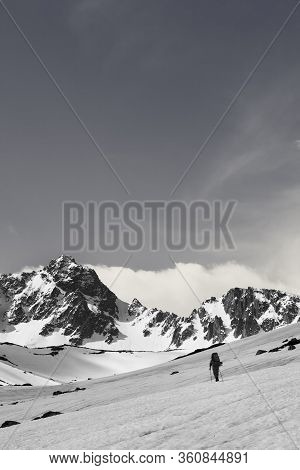 Hiker On Snowy Plateau, Snow Covered Mountain Range And Sunlit Sky With Clouds At Sun Day. Turkey, K