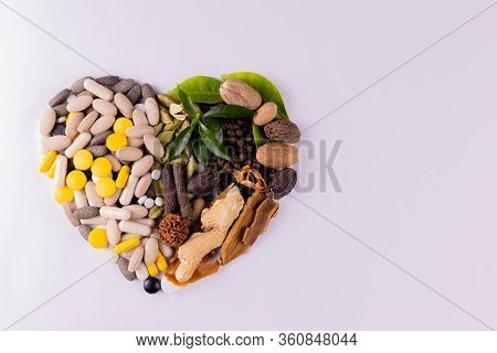 Scattered Black White And Yellow Tablets On A White Background In Heart Shape With Copy Space. Ayurv