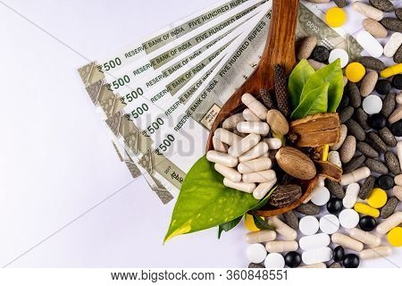 Traditional Medicine Concept.top View Of  Ayurvedic Capsules With Spices In Wooden Spoon, Money And 