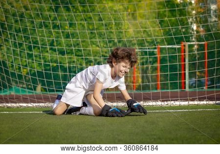 Summer Soccer Tournament For Young Kids. Football Club. Emotions And Joy Of The Game. Young Goalie. 