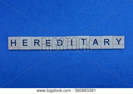 The Text Of The Word  Hereditary From Small Gray Wooden Letters On A Dark Blue Table