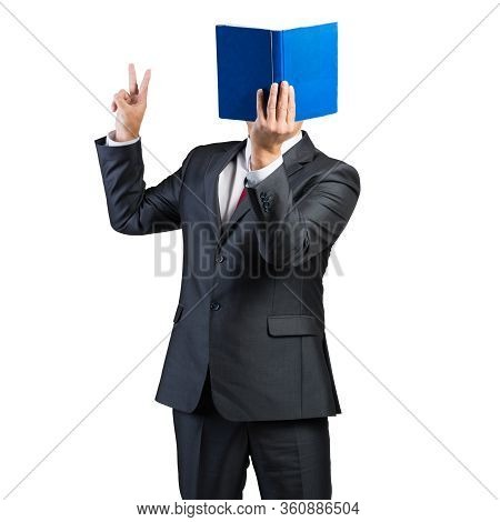 Businessman Covered His Face With Book And Finger Pointing Up. Portrait Of Man In Business Suit And 