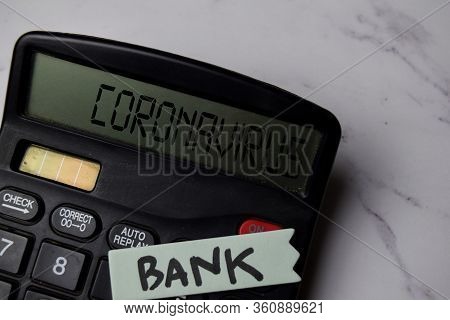 Coronavirus Write On The Calculator And Bank Write On Sticky Note On Office Desk.