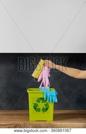 End Of Coronavirus Quarantine. A Female Hand Throws Used Face Masks And Gloves Into A Trash Can. Ret