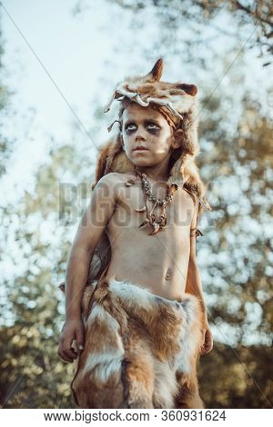 Angry Caveman, Manly Boy. Prehistoric Tribal Boy Outdoors On Nature. Young Shaggy And Dirty Savage, 