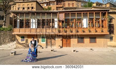 Masuleh, Iran - May 2019: Iranian Couple In Persian Traditional Clothes At Village Of Masuleh In Gil