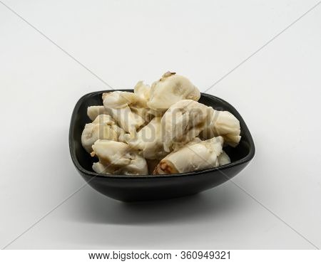 Closed Up Premium Jumbo Lump Of Fresh Blue Crab Meat In Small Black Ceramic Bowl Isolated On White B
