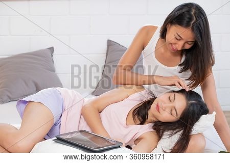 Asian Lesbian Couple Take Care Each Other On Bed In Morning At Cozy Home